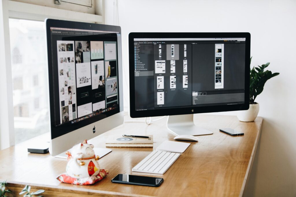 pexels-photo-326503-326503 A well-organized design workspace with dual monitors and design software on display.